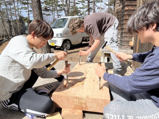 UWC ISAK Japan students making a wood bench with the help of a local craftsman during Project Week.