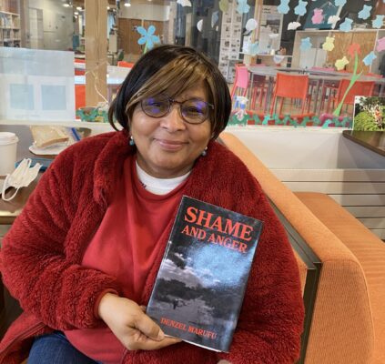 History teacher Ms. Hasham with Denzel's first book