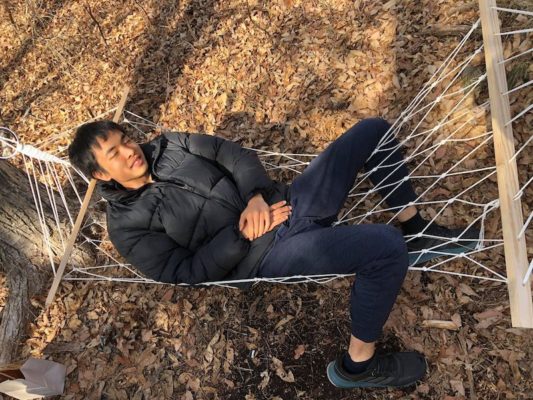 Kai (Japan / Class of 2021) in the hammock he installed on the UWC ISAK Japan campus for his grade 11 CAS project on connexion through nature
