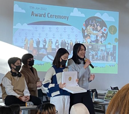 UWC ISAK Japan students presenting the physical Zayed Sustainability Prize 2022 award during an assembly
