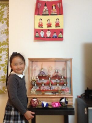 UWC ISAK Japan student Sayaka when she was little in front of hina matsuri dolls, a traditional Japanese festival
