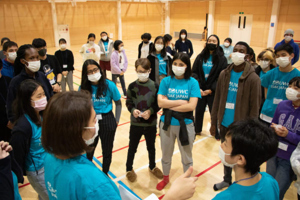 Students and counselors gather around to listen to instructor