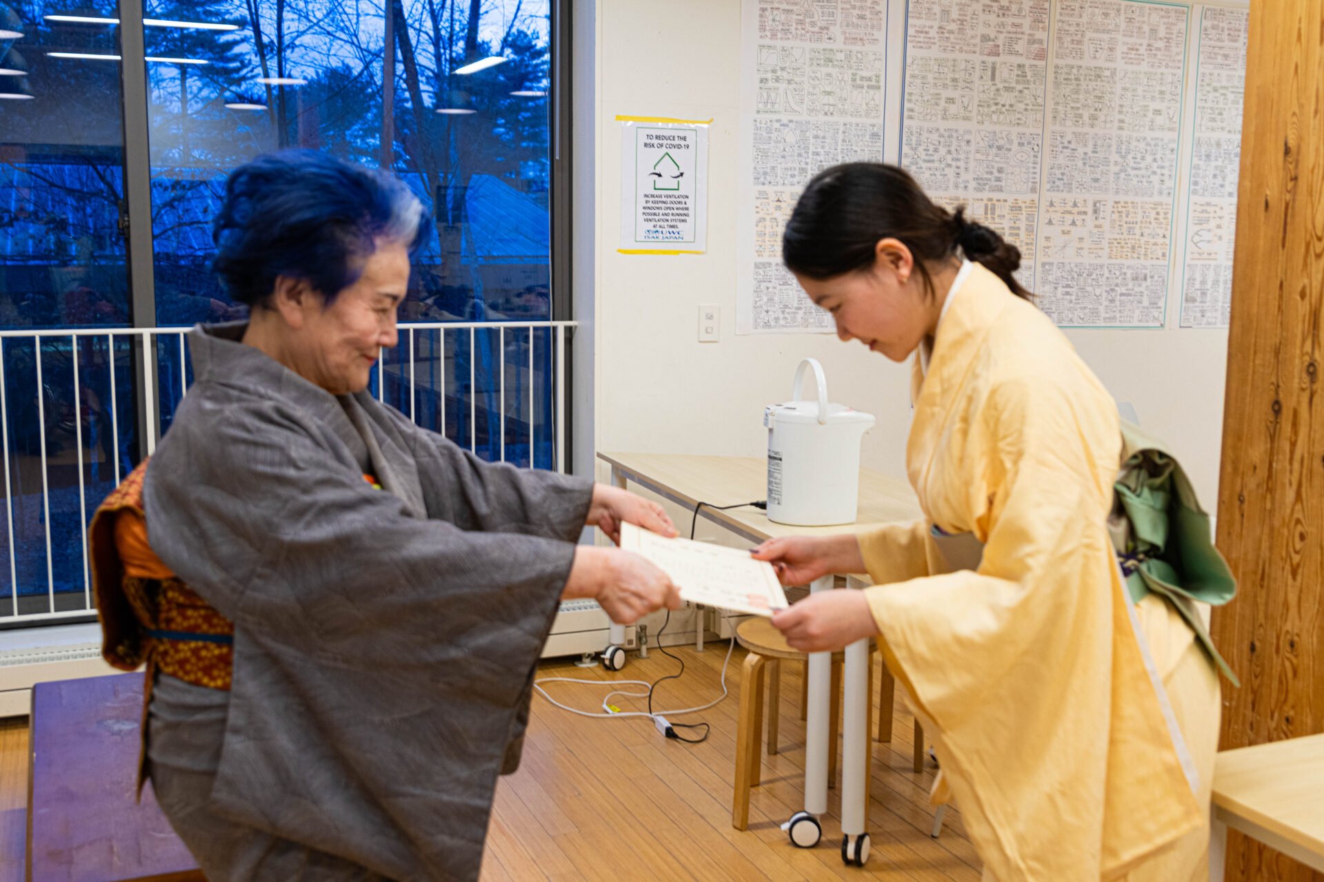 Miki receives her urasenke award from her tea ceremony instructor