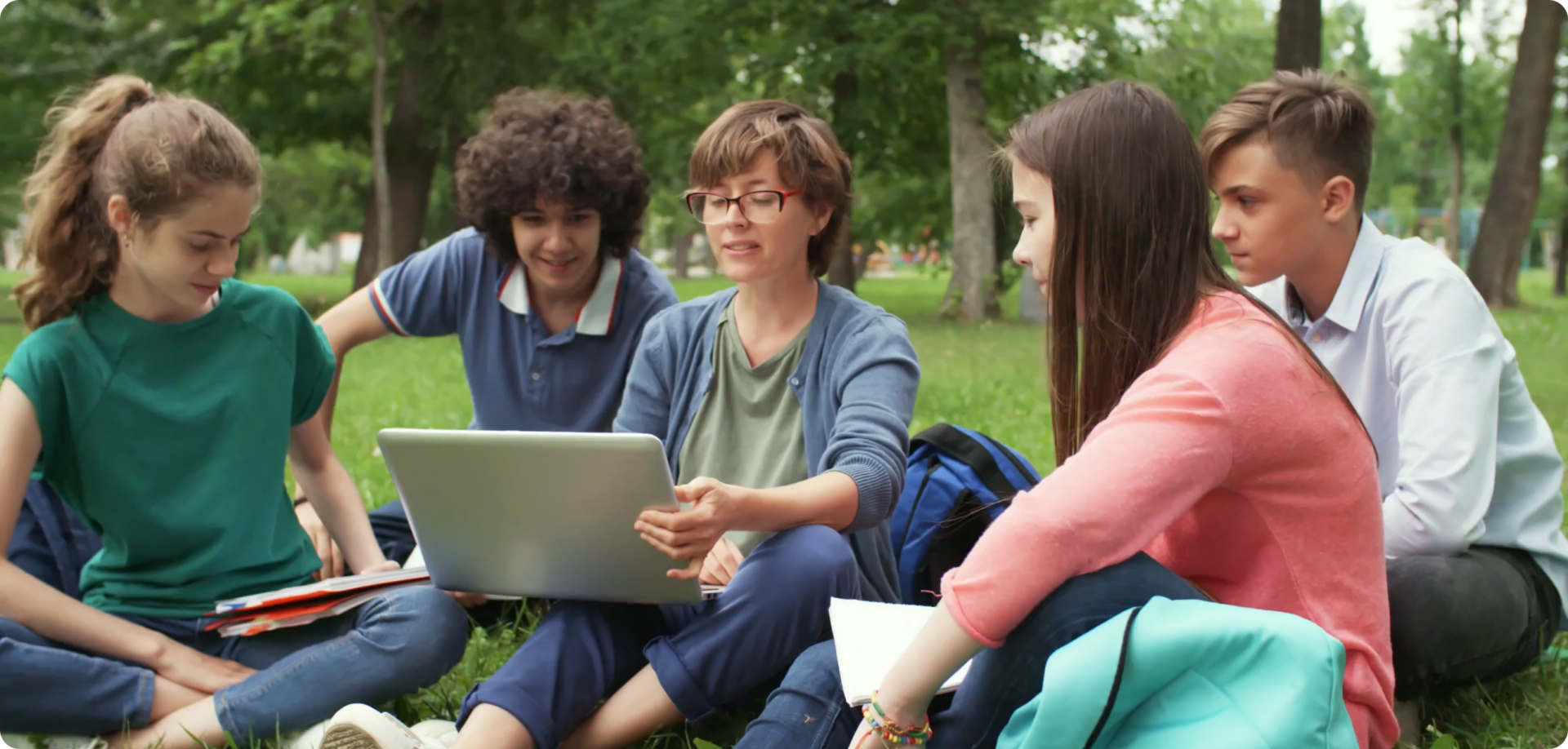 Students working together with laptops outdoors